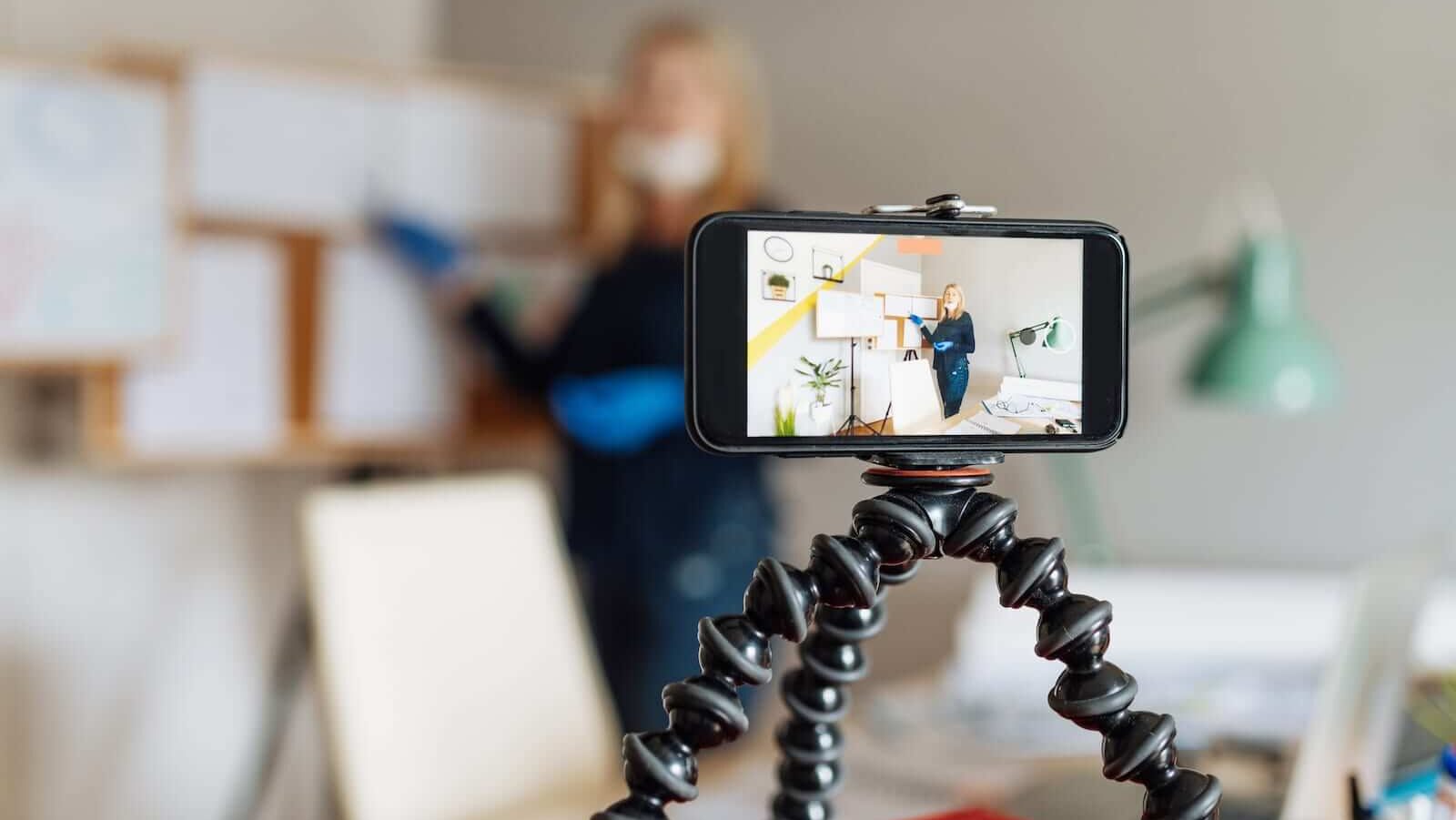 Cell phone mounted on a tripod for video recording Cell phone mounted on a tripod for video recording